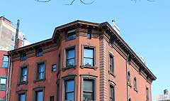 An older townhouse with a large cornice wich will protect the window head and top of the facade from rain